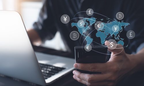 Currency exchange, money transfer, Global Business, FinTech financial technology, online banking, interbank payment concept. Currency exchange, money transfer, FinTech financial technology, Global business, online banking, interbank payment concept. Man using mobile phone and laptop computer with international currencies and world map on virtual screen